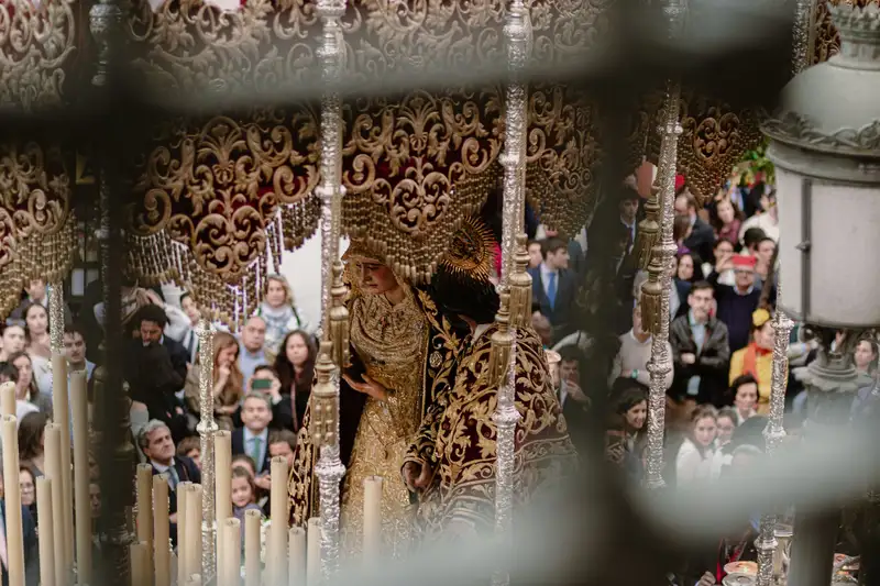 A vibrant and spiritual Semana Santa procession with a Virgin Mary statue in Seville, Spain.